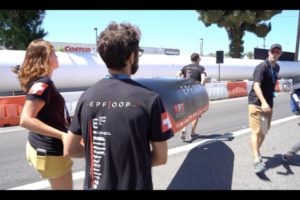 EPFL students in front of the SpaceX tube in which the capsules are launched, July 2018.